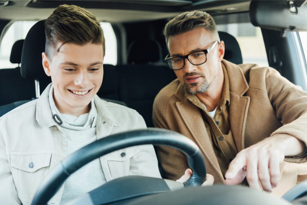 Father teaching son to drive